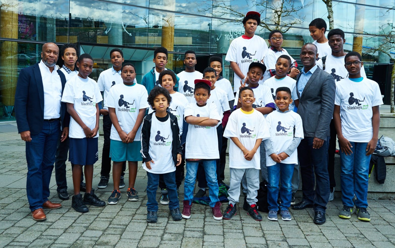 Bryan Johnson, left, a coding workshop crew and Germain Tanoh, who talked to the boys about his path to becoming a mathematician in Canada.